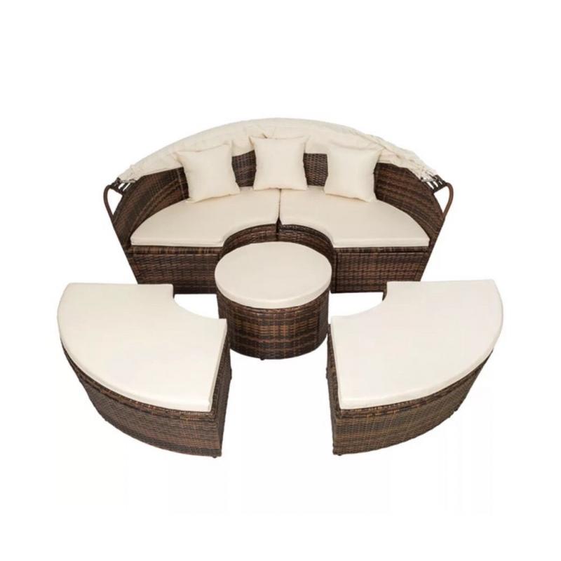 Brown rattan day bed with cream cushions and hood