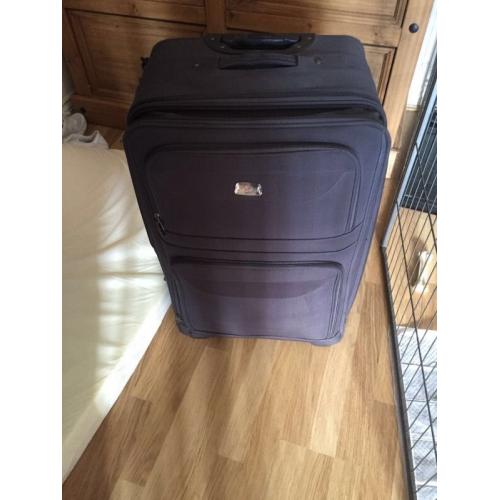Black hold luggage suitcase with handles and wheels