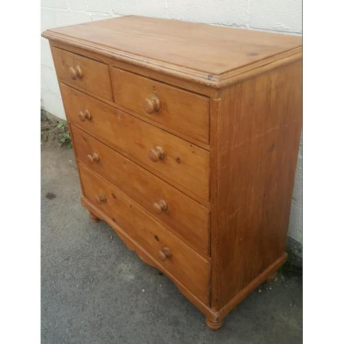 An antique pine chest of drawers