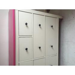 white chest of drawers with pink top