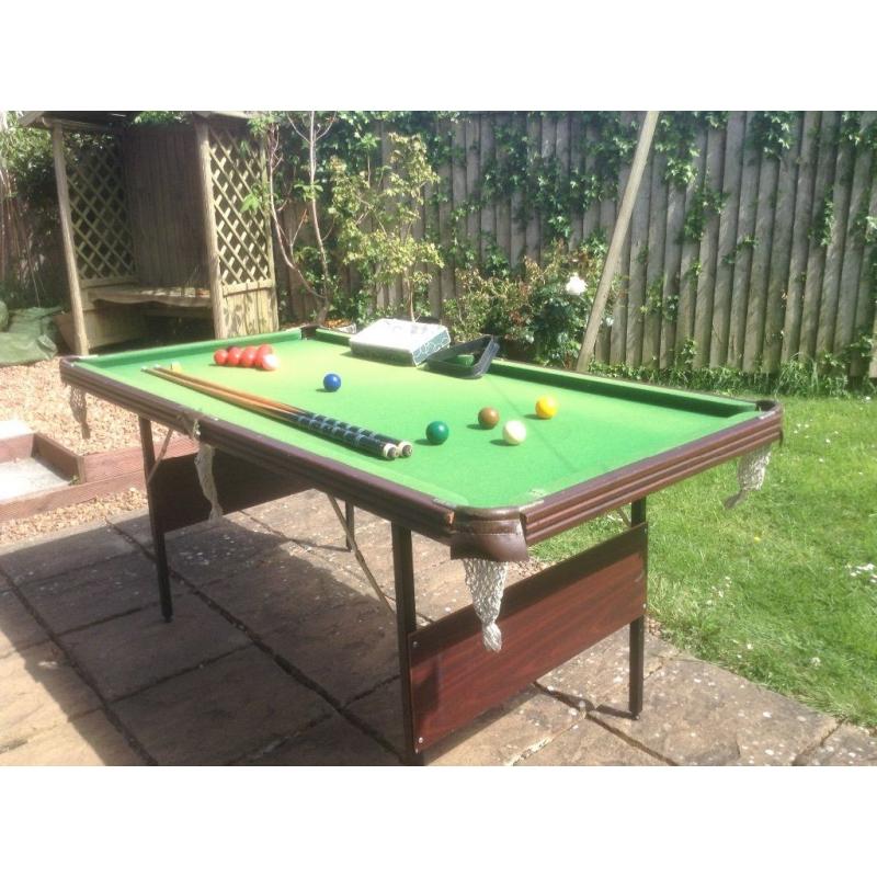 Snooker table with cues and balls