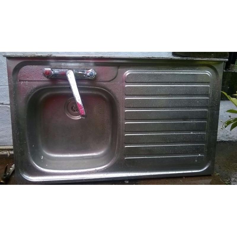 Stainless steel kitchen sink with taps