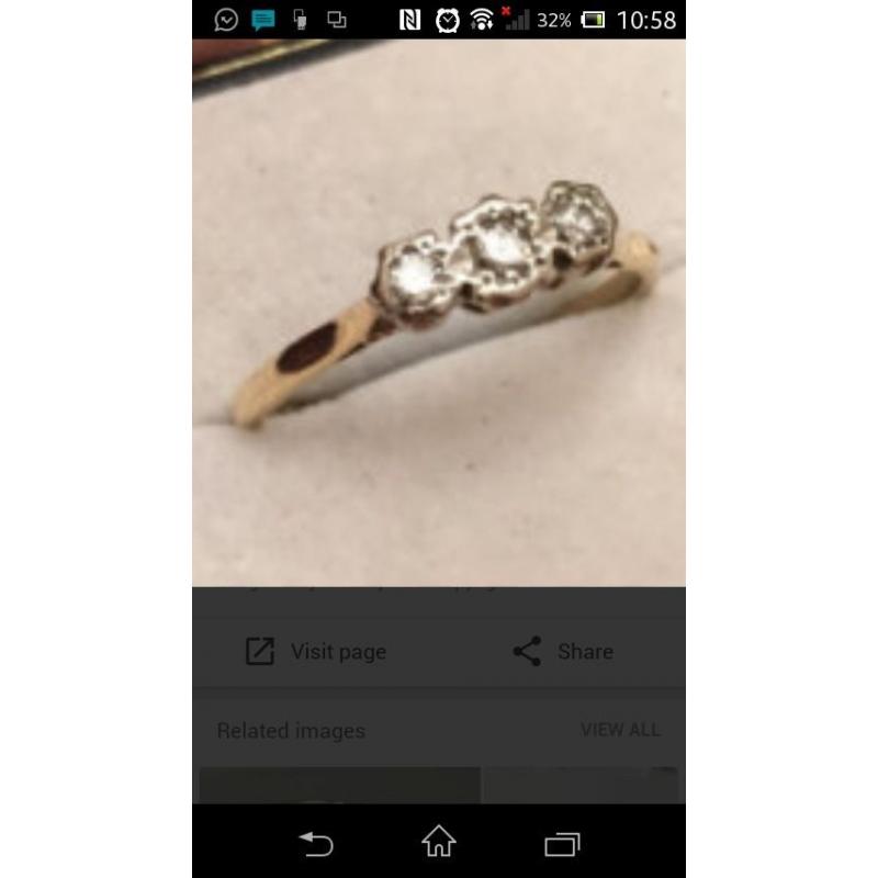 18 carot gold three small stone engagement ring