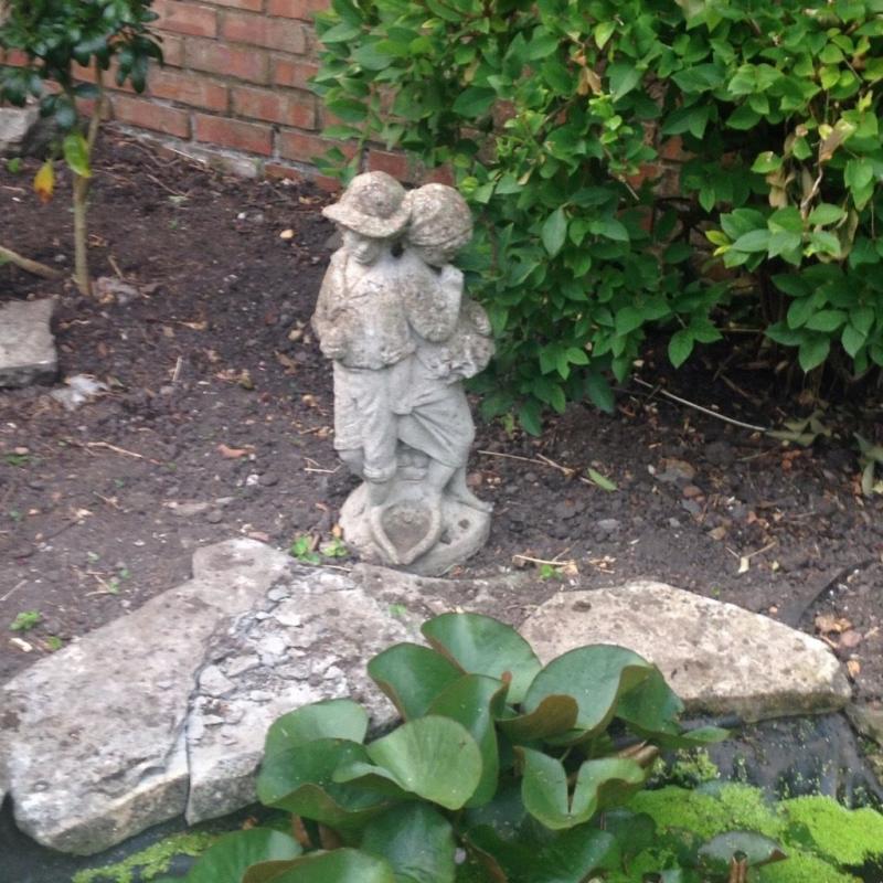 Boy and girl stone statue