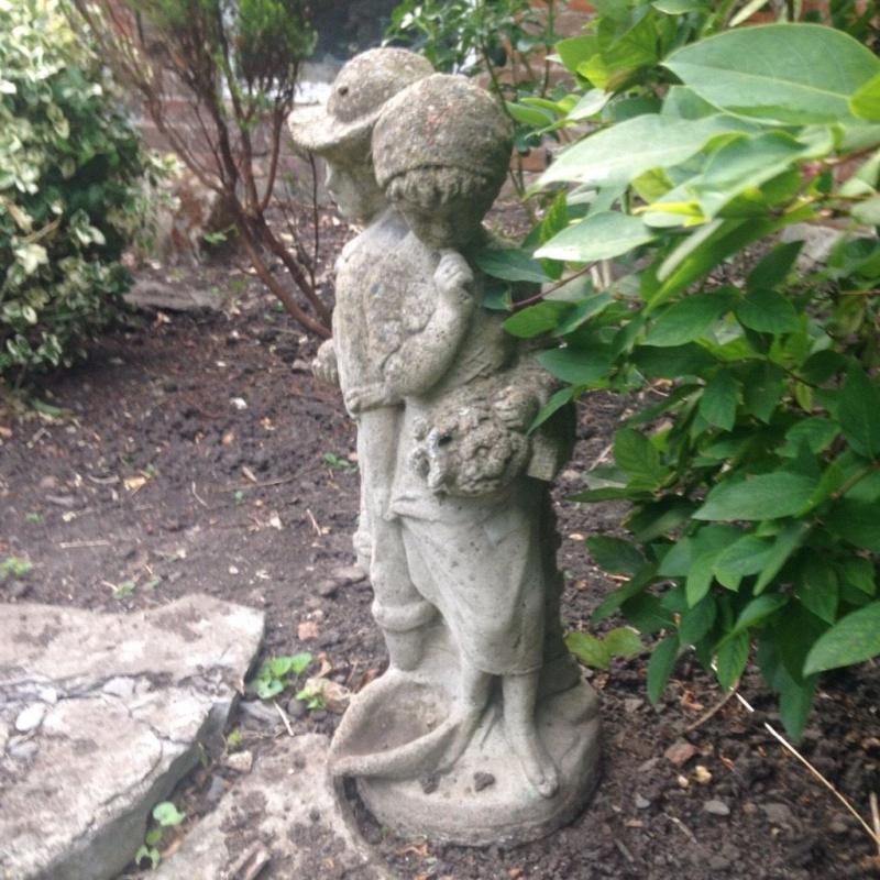 Boy and girl stone statue