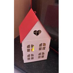 Red and cream house candle holder with flameless candle