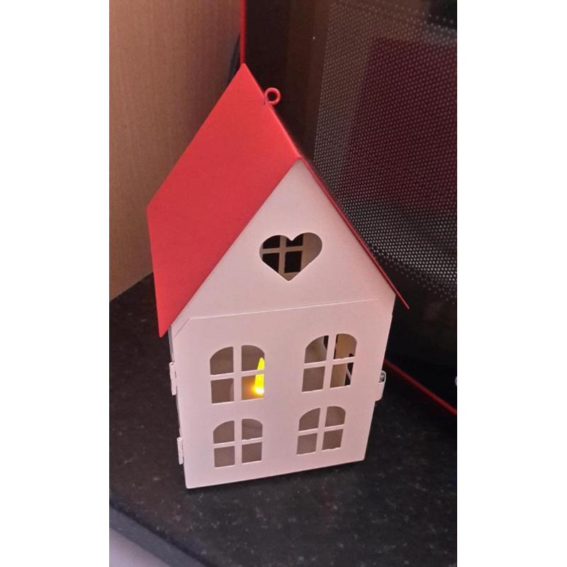 Red and cream house candle holder with flameless candle