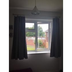 Silver blackout curtains, curtain rings and chrome curtain pole.