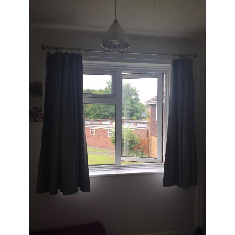 Silver blackout curtains, curtain rings and chrome curtain pole.