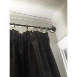 Silver blackout curtains, curtain rings and chrome curtain pole.