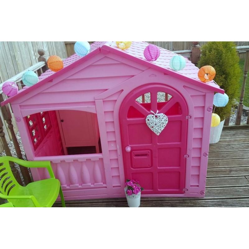 pink playhouse cottage with table and chairs