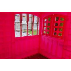 pink playhouse cottage with table and chairs