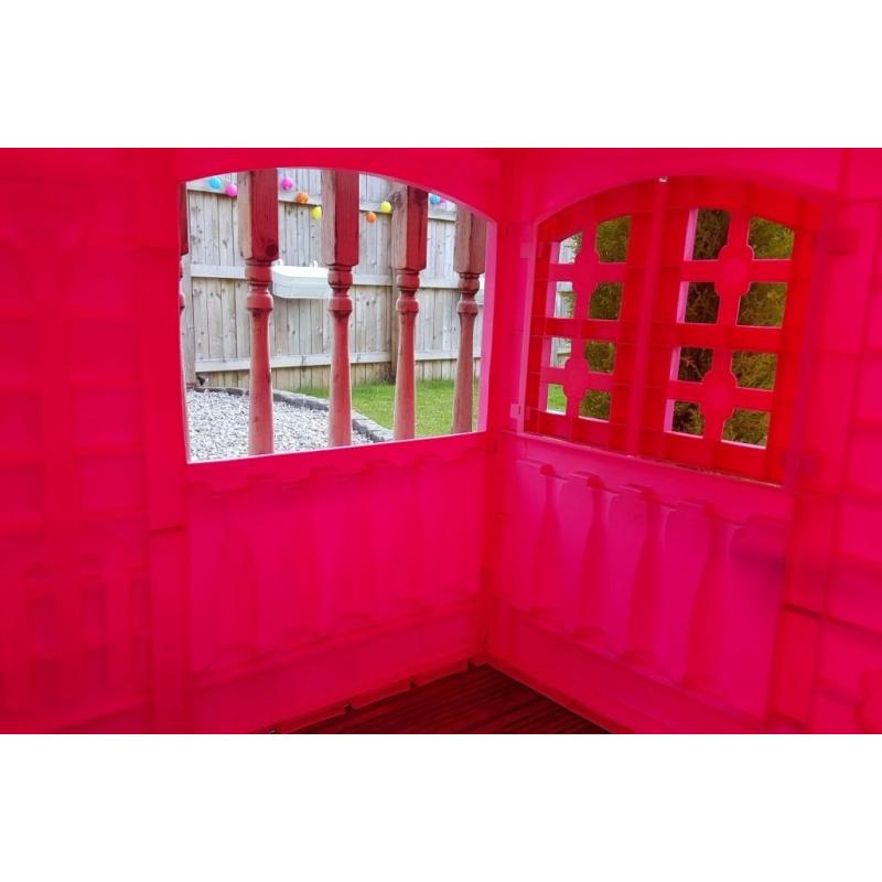 pink playhouse cottage with table and chairs