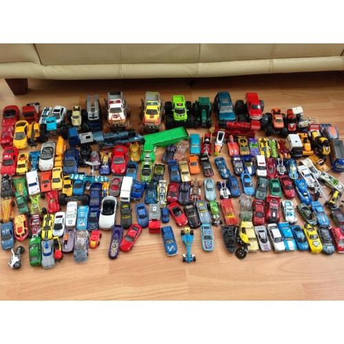 Assortment of kids cars and vehicles. Hot wheels car holders and tracks.