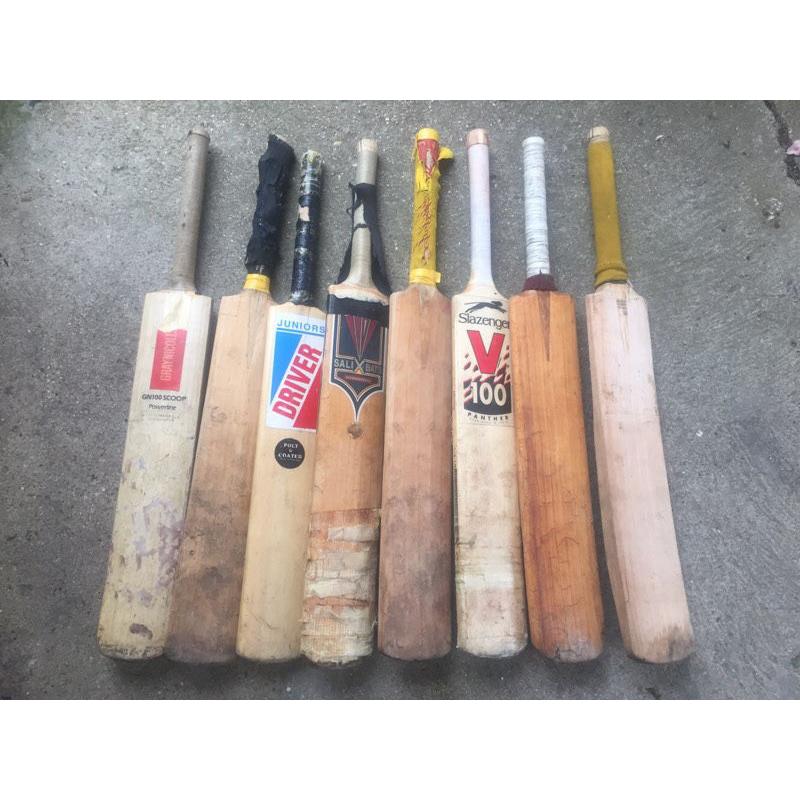Collection of 8 well used Cricket bats for sale, and two pairs of cricket gloves