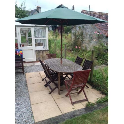 Table, chairs, and parasol