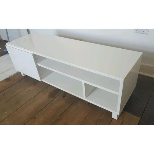 Gloss white TV stand unit with drawers and door at one end