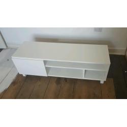 Gloss white TV stand unit with drawers and door at one end