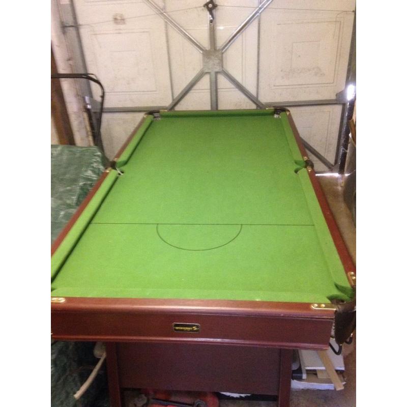 Unicorn pool table with cues and balls.