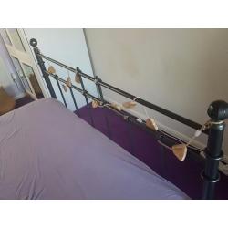 Grey metal double bed.