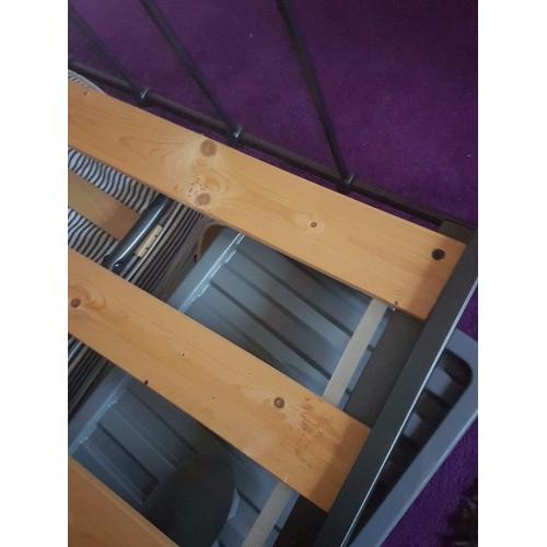 Grey metal double bed.