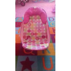 Bath and pink bath seat