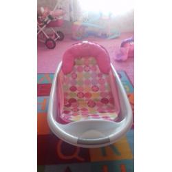 Bath and pink bath seat