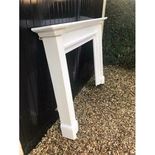 Wooden fireplace mantle painted white