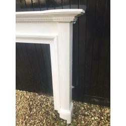 Wooden fireplace mantle painted white