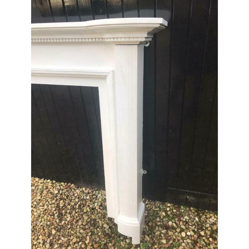 Wooden fireplace mantle painted white