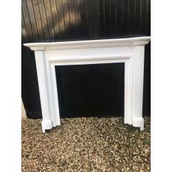 Wooden fireplace mantle painted white