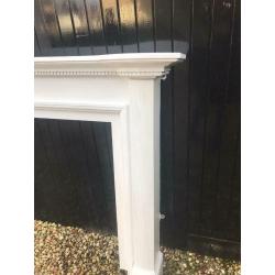 Wooden fireplace mantle painted white