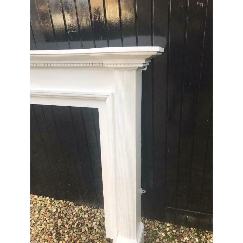 Wooden fireplace mantle painted white