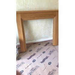 Oak fire place surrounding and marble hearth and electric fire