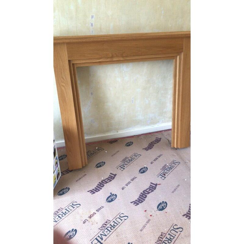 Oak fire place surrounding and marble hearth and electric fire