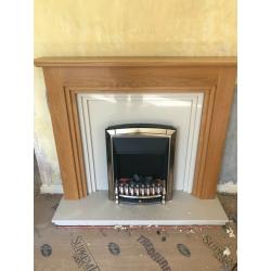 Oak fire place surrounding and marble hearth and electric fire