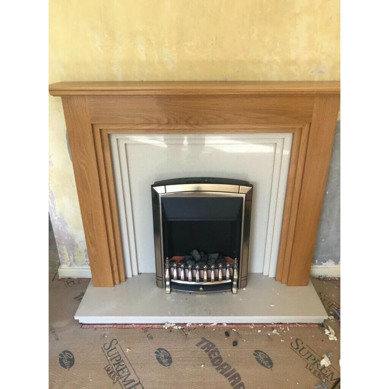 Oak fire place surrounding and marble hearth and electric fire