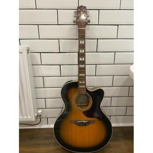 Takomine EG523SC 6 string electro acoustic jumbo guitar in sunburst.